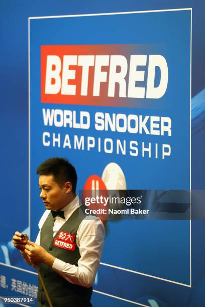 Ding Junhui of China prepares to take a shot during his first round match against Xiao Guodong of China of during day three of the World Snooker...