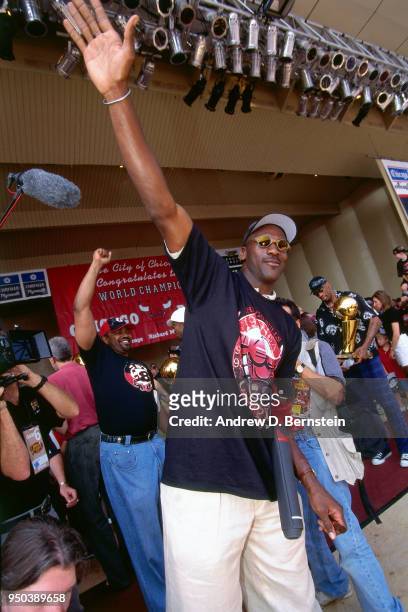 Michael Jordan of the Chicago Bulls waves to the crowd during the 1998 Chicago Bulls Celebration Rally on June 16, 1998 at Grant Park in Chicago,...