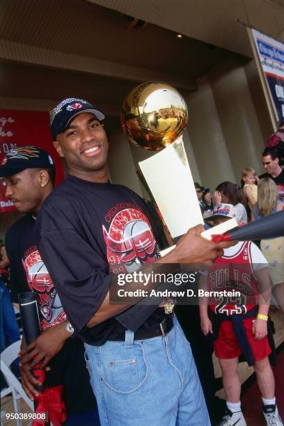 Scott Burrell of the Chicago Bulls with the Larry O'Brien NBA Championship Trophy during the 1998 Chicago Bulls Celebration Rally on June 16, 1998 at...