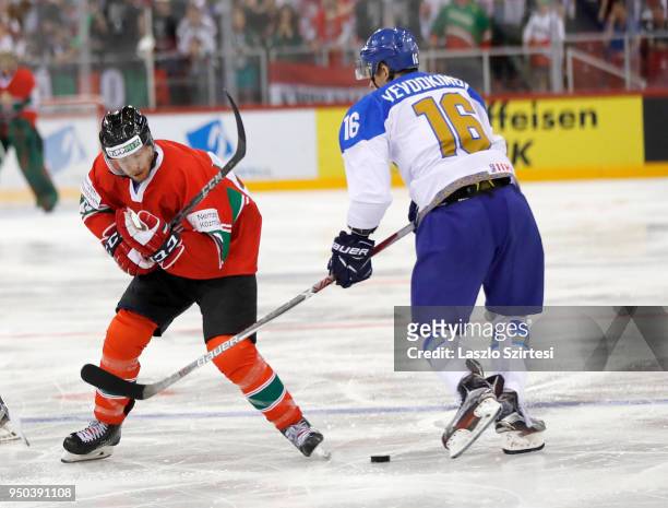 Janos Hari of Hungary competes for the puck with during Pavel Akolzin of Kazakhstan the 2018 IIHF Ice Hockey World Championship Division I Group A...