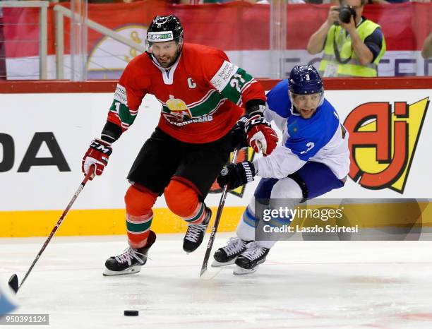 Janos Vas of Hungary competes for the puck with Artemi Lakiza of Kazakhstan during the 2018 IIHF Ice Hockey World Championship Division I Group A...