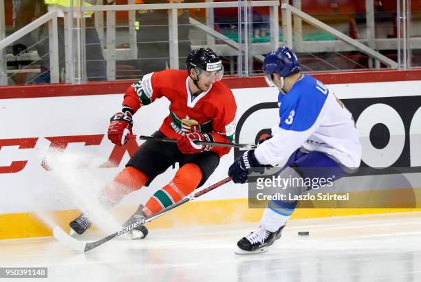 Istvan Sofron of Hungary competes for the puck with Artemi Lakiza of Kazakhstan during the 2018 IIHF Ice Hockey World Championship Division I Group A...