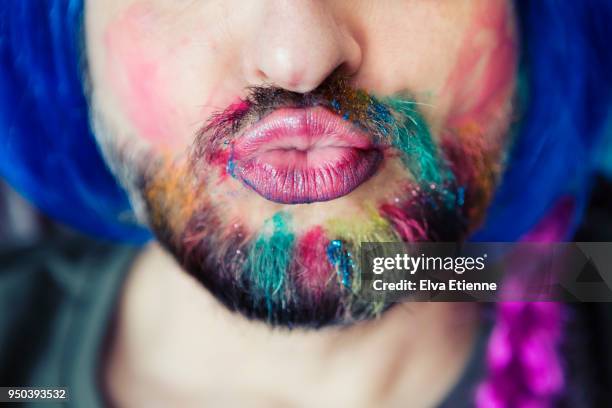 puckering man wearing multicoloured hair chalk through beard, makeup and wig - glitter lips stock pictures, royalty-free photos & images