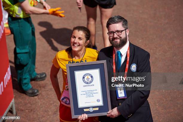 Runners receive a Guinness Record Certificate during the Virgin Money London Marathon in London, England on April 22, 2018.