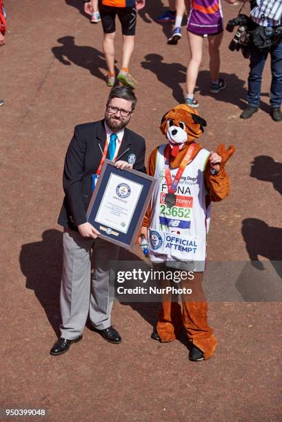 Runners dressed in fancy costumes receive a Guinness Record Certificate during the Virgin Money London Marathon in London, England on April 22, 2018.