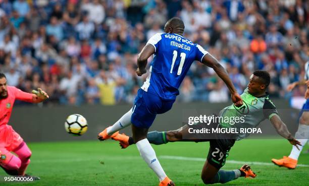 Porto's Malian forward Moussa Marega scores against Vitoria FC's Portuguese midfielder Jose Semedo during the Portuguese league football match...