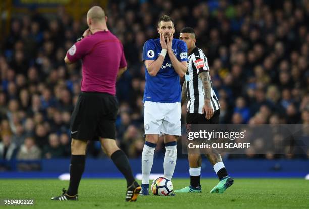 Everton's French midfielder Morgan Schneiderlin reacts as English referee Bobby Madley awards a free-kick to Newcastle during the English Premier...