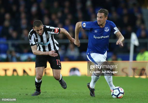 Phil Jagielka of Everton and Islam Slimani of Newcastle United battle for possession during the Premier League match between Everton and Newcastle...