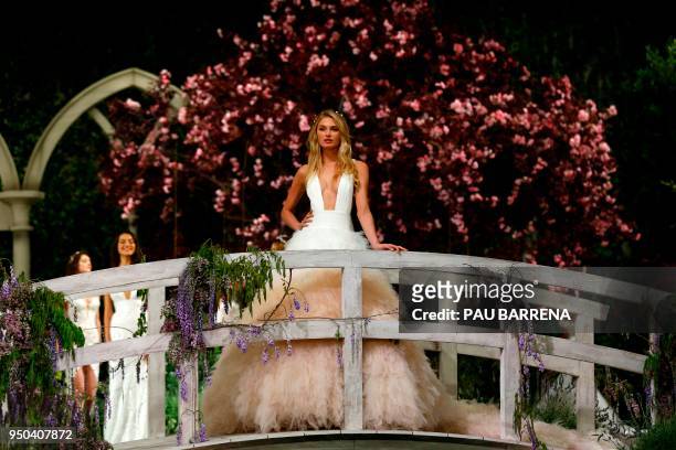 Dutch model Romee Strijd presents creations of the Pronovias 2019 collection during the Barcelona Bridal Week in Barcelona, on April 23, 2018.