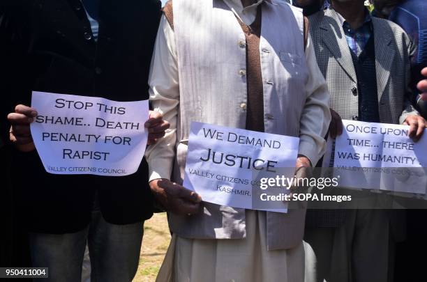 Members of the Valley Citizens Council hold placards during a signature campaign seeking justice in the rape and murder case of an eight-year-old...