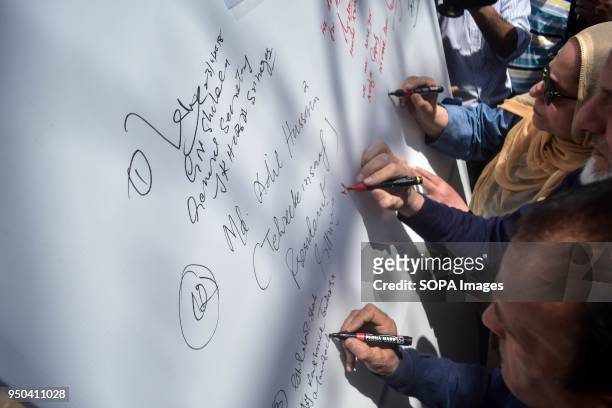 Members of the Valley Citizens Council signs a banner during a signature campaign seeking justice in the rape and murder case of an eight-year-old...