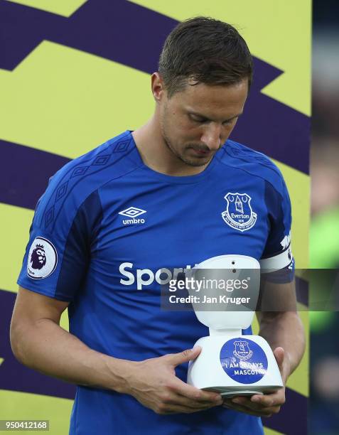 Phil Jagielka of Everton looks at the mascot of the match prior to the Premier League match between Everton and Newcastle United at Goodison Park on...