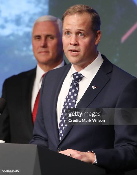 Jim Bridenstine speaks while flanked by Vice President Mike Pence, after a ceremonial swearing in as NASA's new administrator, at NASA Headquarters...