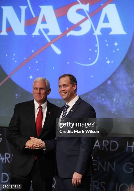 Jim Bridenstine , shakes hands with Vice President Mike Pence, after a ceremonial swearing in as NASA's new administrator, at NASA Headquarters on...