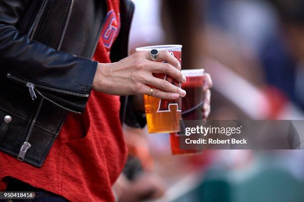 Closeup of Los Angeles Angels fan's hands holding beer cups with Angels logo during game vs Boston Red Sox at Angel Stadium. Anaheim, CA 4/17/2018...