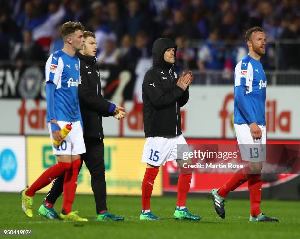 Marvin Ducksch, Johannes van den Bergh and Dominic Peitz of Kiel look dejected after the final whistle after the Second Bundesliga match between...