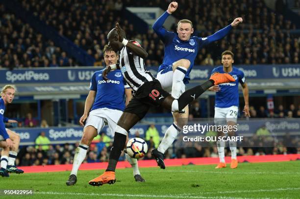 Everton's English striker Wayne Rooney collides with Newcastle United's Senegalese midfielder Mohamed Diame to concede a corner during the English...