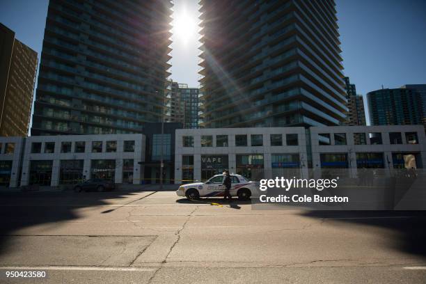 Police officer enters his police car at the cordoned off Yonge St. At Finch Ave. After a van plowed into pedestrians on April 23, 2018 in Toronto,...