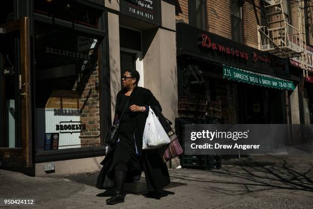 Pedestrian carries plastic bags on Atlantic Avenue, April 23, 2018 in the Brooklyn borough of New York City. New York Governor Andrew Cuomo...