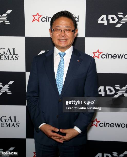 4DPlex CEO Choi Byung-Hwan signs poses after signing a partnership agreement deal with Cineworld Group at Caesars Palace during CinemaCon, the...