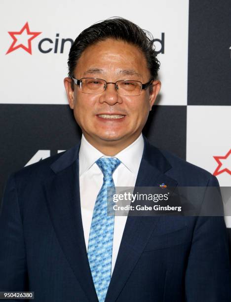 4DPlex CEO Choi Byung-Hwan signs poses after signing a partnership agreement deal with Cineworld Group at Caesars Palace during CinemaCon, the...