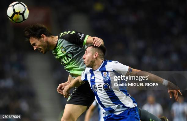 Vitoria FC's Portuguese defender Yohan Tavares heads the ball next to Porto's Mexican midfielder Hector Herrera during the Portuguese league football...