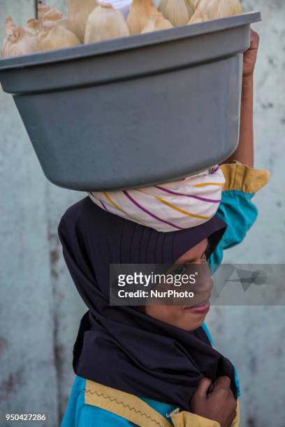 Kupang, East Nusa Tenggara, Indonesia April 24th 2018 : A muslimg girl selling cornd during the parade. People at Kupang, Capital City of East Nusa...