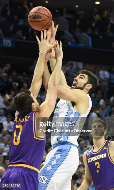 North Carolina's Luke Maye shoots over Lipscomb's Rob Marberry during the first round of the NCAA Tournament at the Spectrum Center in Charlotte,...