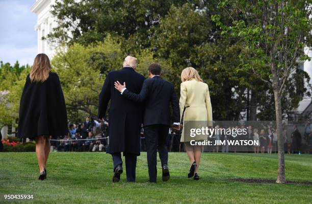 President Donald Trump and First Lady Melania Trump walk after a tree planting ceremony with French President Emmanuel Macron and his wife Brigitte...