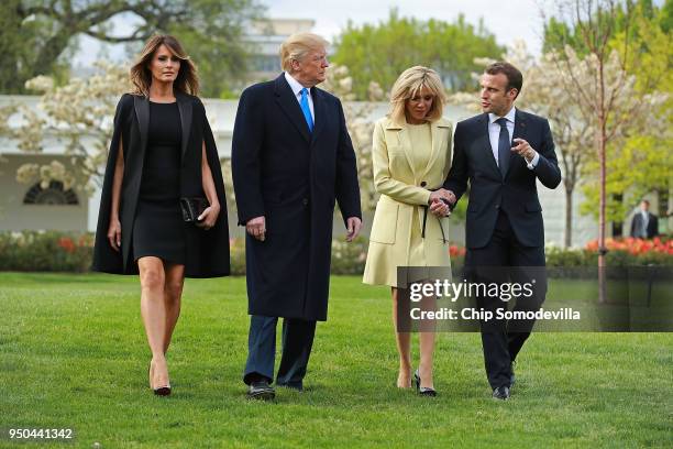 First lady Melania Trump, U.S President Donald Trump, Brigitte Macron and French President Emmanuel Macron walk across the South Lawn before...