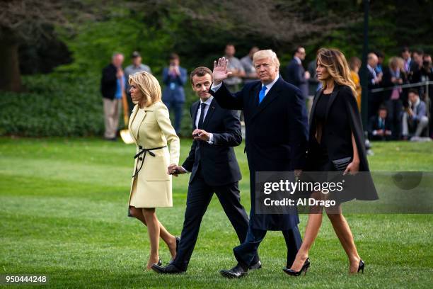 President Donald Trump, French President Emmanuel Macron, Brigitte Macron, and first lady Melania Trump walk across the South Lawn of the White House...