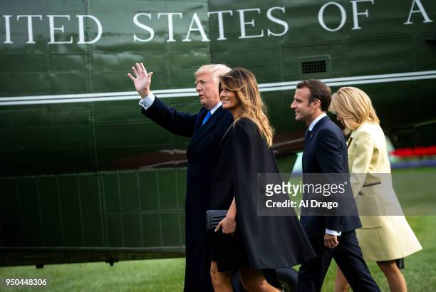 President Donald Trump, first lady Melania Trump, French President Emmanuel Macron and his wife Brigitte Macron, walk to board Marine One before...