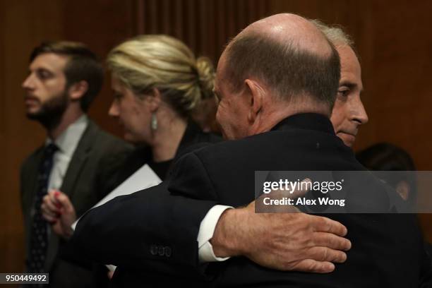 Sen. Bob Corker , chairman of the Senate Foreign Relations Committee, hugs Sen. Chris Coons after a committee meeting April 23, 2018 on Capitol Hill...