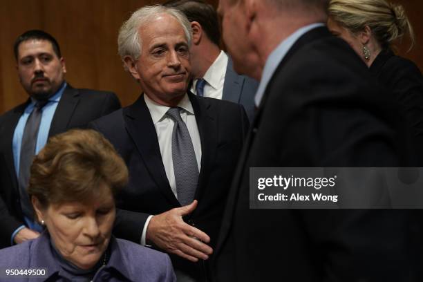 Sen. Bob Corker , chairman of the Senate Foreign Relations Committee, extends his hand for a hand shake with Sen. Chris Coons after a committee...