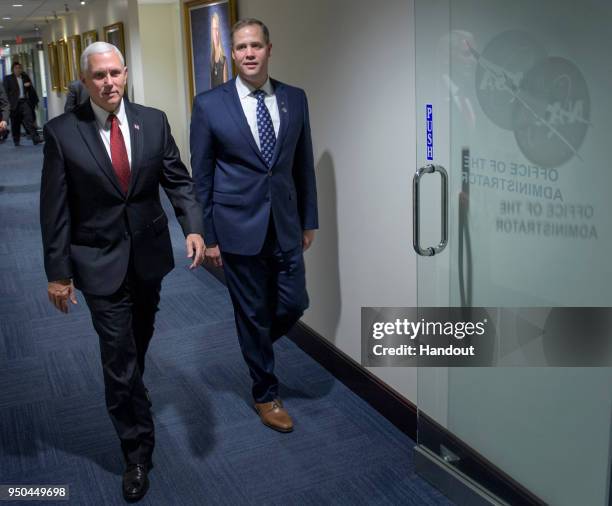 In this handout photo provided by NASA, Vice President Mike Pence, left, and NASA Administrator Jim Bridenstine walk to Bridenstine's office, April...