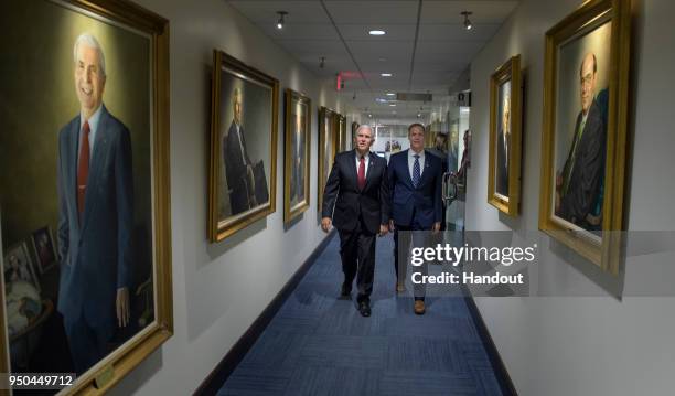 In this handout photo provided by NASA, Vice President Mike Pence, left, and NASA Administrator Jim Bridenstine walk to Bridenstine's office, April...