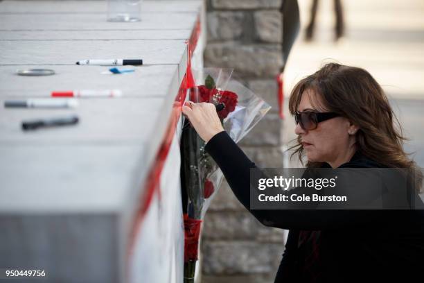 Woman signs a memorial card for the victims near the scene on Yonge St. At Finch Ave., after a van plowed into pedestrians on April 23, 2018 in...