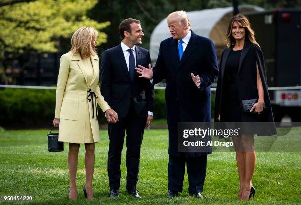 President Donald Trump speaks with French President Emmanuel Macron, his wife Brigitte Macron and first lady Melania Trump as they depart for Mount...