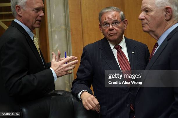 Committee ranking member U.S. Sen. Bob Menendez and Sen. Ben Cardin listen to Sen. Ron Johnson during a Senate Foreign Relations Committee meeting...