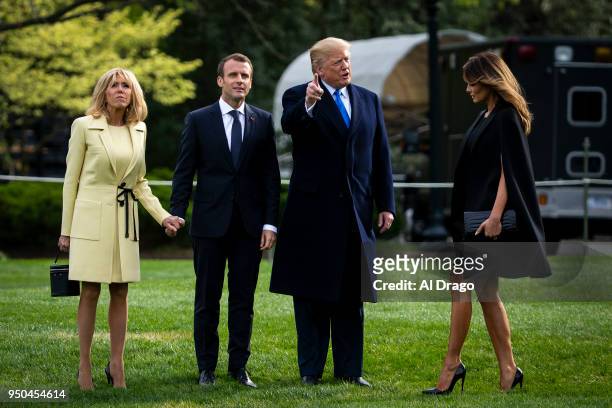 President Donald Trump speaks with French President Emmanuel Macron, his wife Brigitte Macron and first lady Melania Trump as they depart for Mount...