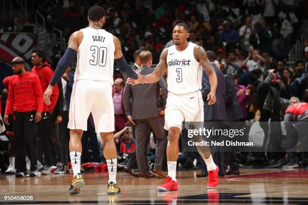 Mike Scott of the Washington Wizards high fives Bradley Beal of the Washington Wizards during the game against the Toronto Raptors in Game Three of...