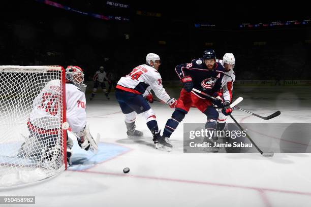 Boone Jenner of the Columbus Blue Jackets and Michal Kempny of the Washington Capitals battle for position as they skate after a loose puck during...