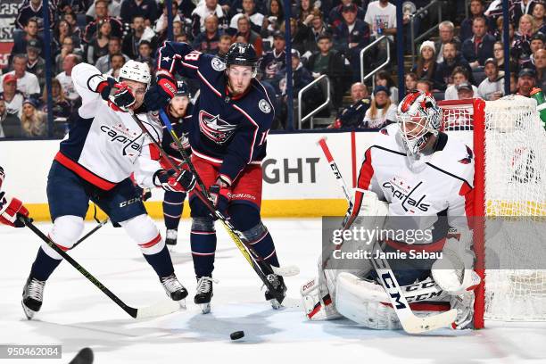 Goaltender Braden Holtby of the Washington Capitals defends the net as Dimitry Orlov of the Washington Capitals and Pierre-Luc Dubois of the Columbus...