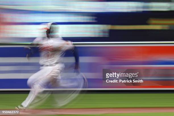 Adam Jones of the Baltimore Orioles advances bases on a hit by teammates Chris Davis against the Cleveland Indians during the second inning at Oriole...