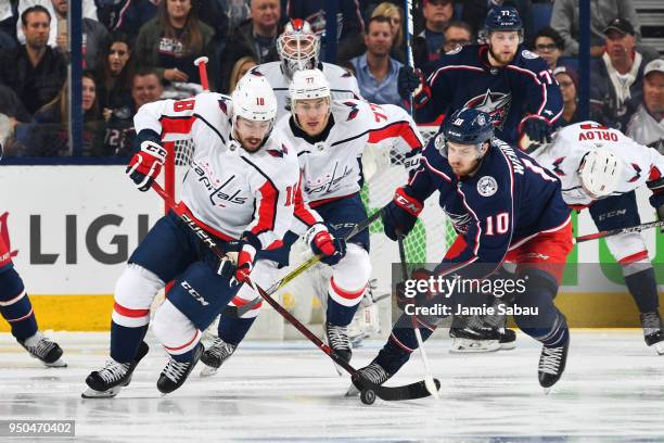 Chandler Stephenson of the Washington Capitals and Alexander Wennberg of the Columbus Blue Jackets battle for the puck during the second period in...