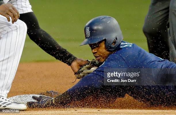 Jean Segura of the Seattle Mariners slides into second base to beat the tag of Tim Anderson of the Chicago White Sox for a double during the first...