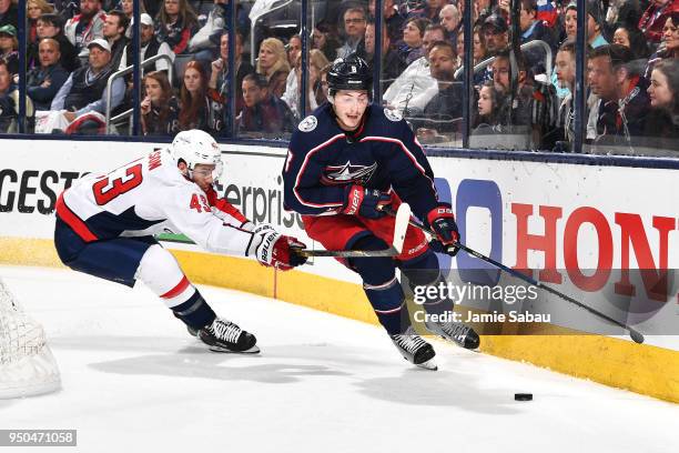 Zach Werenski of the Columbus Blue Jackets attempts to keep the puck from Tom Wilson of the Washington Capitals during the second period in Game Six...