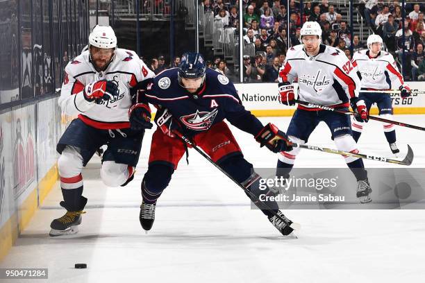 Alex Ovechkin of the Washington Capitals and Seth Jones of the Columbus Blue Jackets skate after a loose puck during the second period in Game Six of...