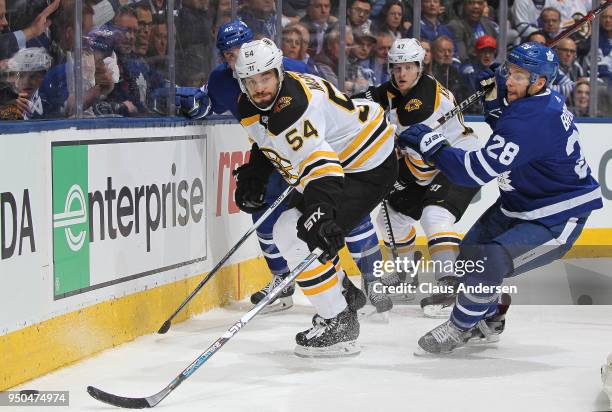 Adam McQuaid of the Boston Bruins skates after the puck against Connor Brown of the Toronto Maple Leafs in Game Six of the Eastern Conference First...