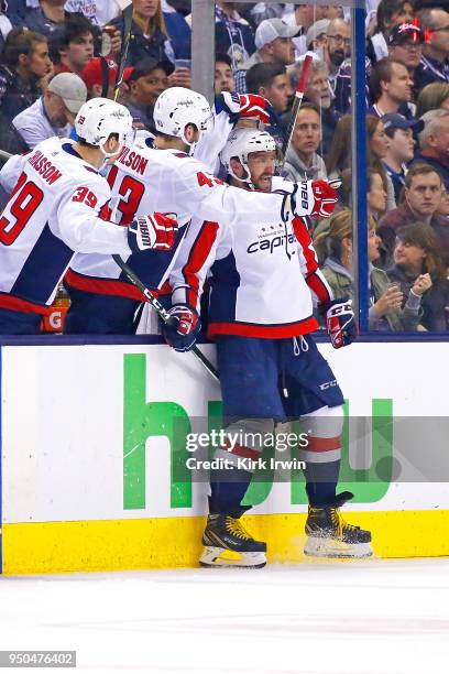 Alex Ovechkin of the Washington Capitals is congratulated by his teammates after scoring a power play goal during the second period in Game Six of...